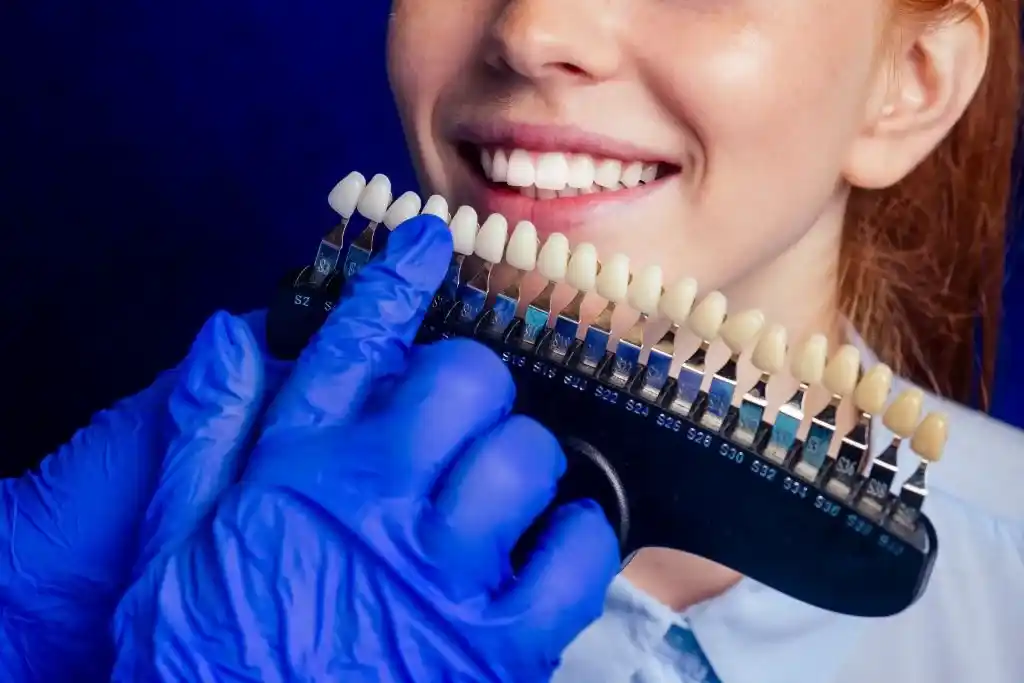 dentist works on tooth crown in dental laboratory